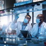 two scientist collaborating at bench